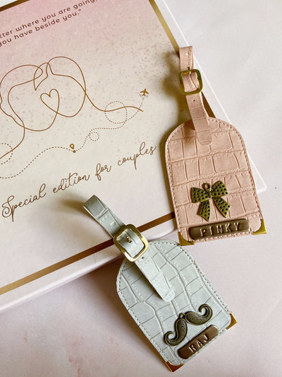 Couple Luggage Tag by TPC Gifts. Salmon Pink and Coral Grey. Croc Texture, lying on gift box.