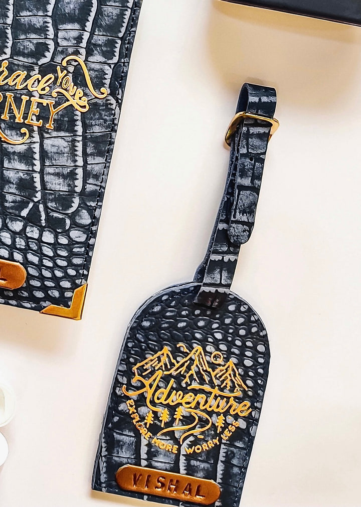 Leather Passport cover and Luggage Tag set by TPC gifts. The luggae tag is in denim blue coloyur with a sticker on it. at the side there is the passport cover.  